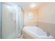 Elegant bathroom offers a glass shower enclosure and a soaking tub for spa-like experience at 4516 Seagull Dr # 405, New Port Richey, FL 34652