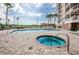 Community pool and hot tub with lounge chairs and umbrellas for relaxation and enjoyment at 4516 Seagull Dr # 405, New Port Richey, FL 34652