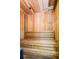 Relaxing cedar sauna with a wooden bench and well-lit interior at 4516 Seagull Dr # 405, New Port Richey, FL 34652