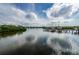 Scenic view of a serene body of water with a boat dock and boats, under a partly cloudy sky at 4516 Seagull Dr # 405, New Port Richey, FL 34652