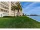 Backyard showing the lawn, walkway, waterfront, and condo building in the background at 4525 Cove Cir # 805, St Petersburg, FL 33708