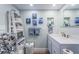 Cozy bathroom featuring decoratively-arranged towels, marine-themed artwork, and ample vanity storage at 4525 Cove Cir # 805, St Petersburg, FL 33708