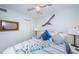 Comfortable bedroom featuring coastal-themed decor, a ceiling fan, and light blue walls at 4525 Cove Cir # 805, St Petersburg, FL 33708