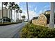 Community entrance with 'Sea Towers' sign with palm trees and tropical landscaping at 4525 Cove Cir # 805, St Petersburg, FL 33708