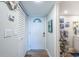 Inviting hallway featuring a closet, a white front door, and coastal-themed decorations at 4525 Cove Cir # 805, St Petersburg, FL 33708