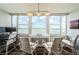 Bright windowed living space features a desk and chairs with a gorgeous water view and boats sailing on a clear day at 4525 Cove Cir # 805, St Petersburg, FL 33708