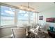 Bright windowed living space features a desk and chairs with a gorgeous water view and boats sailing on a clear day at 4525 Cove Cir # 805, St Petersburg, FL 33708