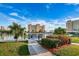 Waterfront view of condominium buildings with lush landscaping and a pathway in a coastal community at 4525 Cove Cir # 805, St Petersburg, FL 33708