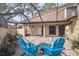 Relaxing screened-in back patio with brick pavers, outdoor seating, and lush landscaping, perfect for outdoor living at 4801 Umber Ct, Tampa, FL 33624