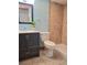 Well-lit bathroom features a modern vanity, mirror, toilet, and a tiled shower at 4801 Umber Ct, Tampa, FL 33624