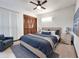 Well-lit primary bedroom with a ceiling fan, wood-look floors, soft neutral colors, and closet with wood shutter doors at 4801 Umber Ct, Tampa, FL 33624