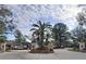 Elegant community entrance featuring a brick monument, lush flower beds, and palm trees, adding to the neighborhood's appeal at 4801 Umber Ct, Tampa, FL 33624