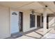 Covered front porch with white door, outdoor ceiling fans and decorative concrete flooring at 4801 Umber Ct, Tampa, FL 33624