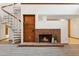 Spacious living room features a spiral staircase, tiled fireplace, and wood built-in shelves at 4801 Umber Ct, Tampa, FL 33624