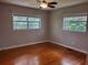 This cozy bedroom features beautiful hardwood floors and a ceiling fan at 4802 W San Jose St, Tampa, FL 33629