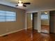 Spacious bedroom featuring hardwood floors, ceiling fan, and closet with mirrored sliding doors at 4802 W San Jose St, Tampa, FL 33629