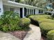 Inviting front entrance with a winding walkway, lush landscaping, and a glimpse of the home's architectural details at 4802 W San Jose St, Tampa, FL 33629