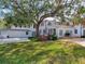 Expansive backyard featuring a brick patio, outdoor grill, and a covered balcony on the second floor at 5001 S Shore Crest Cir, Tampa, FL 33609