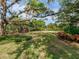 Well-maintained backyard with mature trees, lush landscaping, and ample shade, creating a serene outdoor environment at 5001 S Shore Crest Cir, Tampa, FL 33609