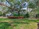 Lush backyard with mature trees, manicured landscaping, and a private fence, providing a tranquil and secure outdoor space at 5001 S Shore Crest Cir, Tampa, FL 33609