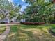 Expansive backyard with lush greenery, featuring manicured landscaping and mature trees, perfect for outdoor enjoyment at 5001 S Shore Crest Cir, Tampa, FL 33609