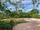 Backyard featuring an in-ground pool surrounded by brick pavers and lush greenery at 5001 S Shore Crest Cir, Tampa, FL 33609