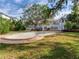 Spacious backyard with an in-ground pool, mature trees, and a well-maintained lawn, creating a private oasis at 5001 S Shore Crest Cir, Tampa, FL 33609