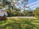 Backyard featuring an in-ground pool with brick surround and mature landscaping at 5001 S Shore Crest Cir, Tampa, FL 33609