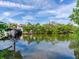 Scenic waterfront view showcasing lush greenery, a boat dock, and clear skies reflecting in the tranquil water at 5001 S Shore Crest Cir, Tampa, FL 33609