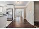 Hallway view from kitchen, with hardwood floors and stainless steel refrigerator at 5020 16Th N Ave, St Petersburg, FL 33710