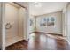 Bright laundry room with tile floor and wooden-style flooring leading to bedroom at 5020 16Th N Ave, St Petersburg, FL 33710