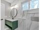 Stylish bathroom with a green vanity, marble accents, and modern fixtures at 525 Lamara Ne Way, St Petersburg, FL 33704