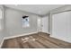 Bedroom featuring wood flooring, a double door closet, and natural light from windows at 525 Lamara Ne Way, St Petersburg, FL 33704