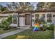 Inviting front entrance showcases updated landscaping and a well-maintained walkway at 525 Lamara Ne Way, St Petersburg, FL 33704