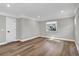 Spacious main bedroom with wood-look floors, a large window, and a neutral color palette at 525 Lamara Ne Way, St Petersburg, FL 33704