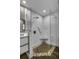 Modern shower with frameless glass, pebble tile, and grab bar at 525 Lamara Ne Way, St Petersburg, FL 33704