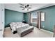 Cozy bedroom with neutral carpet, a quilted bedspread, ceiling fan, and a view from the window at 6929 Breezy Palm Dr, Riverview, FL 33578