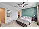 Cozy bedroom with neutral carpet, a quilted bedspread, ceiling fan, and a view from the window at 6929 Breezy Palm Dr, Riverview, FL 33578