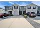 Well-manicured townhome with front yard, driveway, and attached garages on a sunny day at 6929 Breezy Palm Dr, Riverview, FL 33578