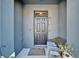 Front door with welcome mat, bench, potted plant and overhead window at 6929 Breezy Palm Dr, Riverview, FL 33578