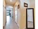 Open hallway leading to the living area, with tile flooring and neutral walls at 6929 Breezy Palm Dr, Riverview, FL 33578