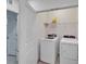 Laundry room with a washer and dryer, shelf, and utility closet at 6929 Breezy Palm Dr, Riverview, FL 33578