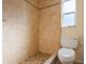 Beige tiled bathroom with shower and toilet at 7353 Knoll Dr, New Port Richey, FL 34653