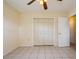 Bedroom with tile floors and double door closet at 7353 Knoll Dr, New Port Richey, FL 34653