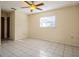 Spacious bedroom with tile floors and ceiling fan at 7353 Knoll Dr, New Port Richey, FL 34653