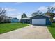 Front view of a charming blue house with a white garage door at 7353 Knoll Dr, New Port Richey, FL 34653