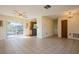 Living room with tile floors, ceiling fan, and access to the kitchen at 7353 Knoll Dr, New Port Richey, FL 34653