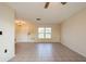 Spacious living room with tile floors and a chandelier at 7353 Knoll Dr, New Port Richey, FL 34653