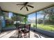 Screened porch with table and chairs at 7353 Knoll Dr, New Port Richey, FL 34653