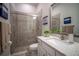 Bathroom featuring a glass-doored shower, toilet, vanity with granite countertop, and decorative art at 7432 Paradiso Dr, Apollo Beach, FL 33572